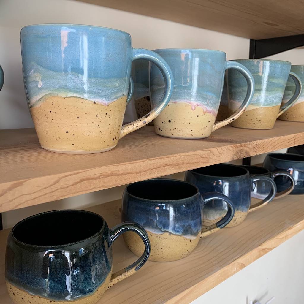 Beach mugs line the shelves of the studio.