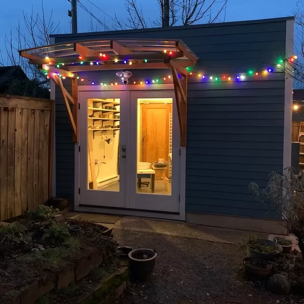 Pottery studio strung with colored lights
